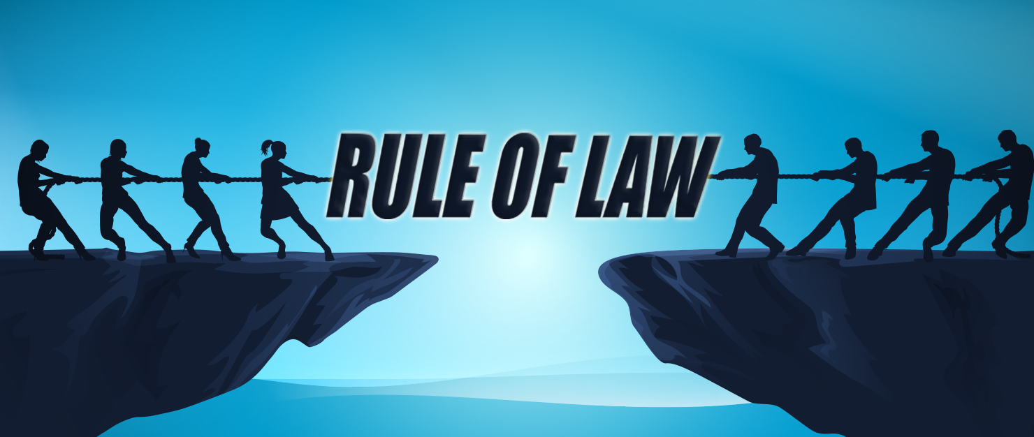 tug of war on cliff with rule of law written between each side